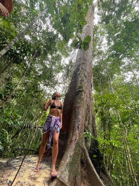 Mulher em meio a natureza com árvores verdes